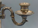 a silver candelier with two candles on it