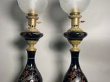 pair of black and gold vase lamps with floral designs on them