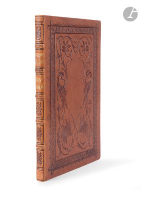 a brown leather book with an intricate design on the cover