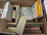 a cardboard box filled with books and other books