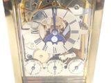 a gold clock with a blue face and a white face