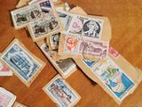 a pile of stamps on a table next to a cup of coffee