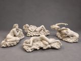 a group of four statues of a woman and a man on a rock