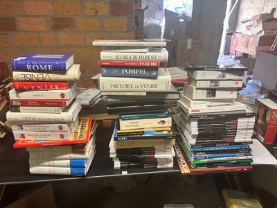 many books stacked on top of each other on a table