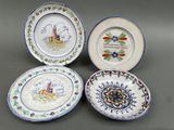 three plates with designs on them are sitting on a table