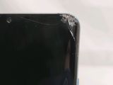 a close up of a cell phone with a broken screen
