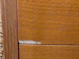 a close up of a door handle on a wooden cabinet