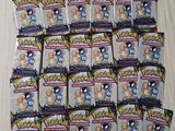 a pile of pokemon trading cards sitting on top of a table
