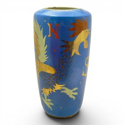 a blue vase with a gold dragon design on it