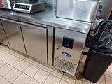 a kitchen with a bunch of appliances and a trash bag on the counter