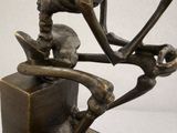 a bronze sculpture of a man on a skateboard on a block