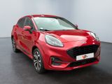 a red car parked in a room with a black floor