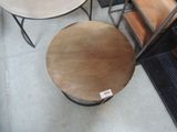 a table that has a small round wooden table on it