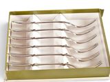 six forks in a box on a white surface