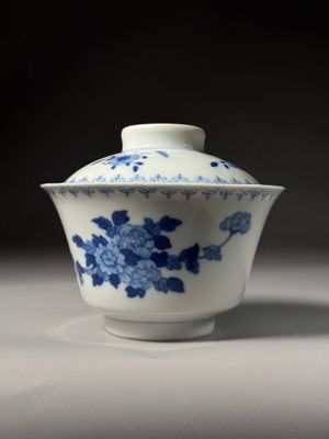 blue and white porcelain bowl with flowers on it on a table
