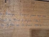 a piece of wood that has writing on it