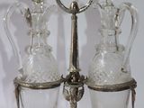 a silver plate with three glass decanters on it
