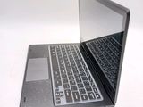 a laptop that is open on a white surface
