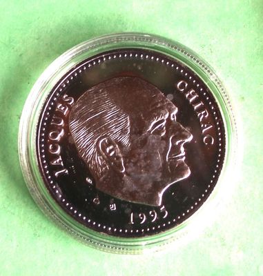 a close up of a coin on a green surface