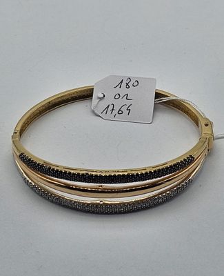 three bang bracelets with black and gold beads on a white surface
