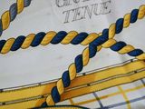 a close up of a yellow and blue scarf with a knot on it