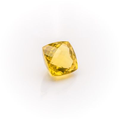 a yellow sapphire stone on a white background