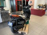 a scooter that is sitting on a pallet in a showroom