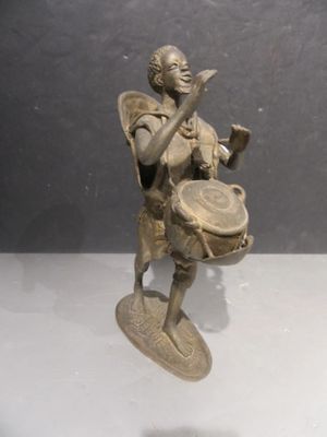 bronze figurine of a boy with a drum and a basket
