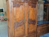 a wooden armoire with a marble top in a room