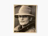 a black and white photo of a man wearing a hat