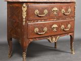 a small chest of drawers with a marble top