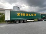 a semi truck that is parked in front of a building