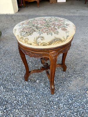 an image of a small stool with a floral upholstered seat