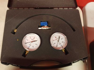 two gauges that are sitting in a case