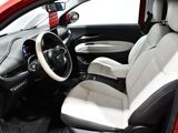 the interior of a small red car with a steering wheel