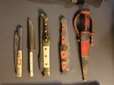 many different types of knives and knives on the table