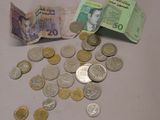 une pile d'argent posée sur une table à côté d'une pile de pièces de monnaie