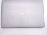 dell laptop computer sitting on a white surface with a white background