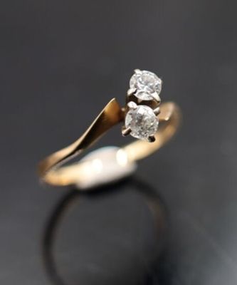 gros plan d'une bague en diamant sur une surface noire