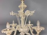 an image of a chandelier made of glass with a bird on it