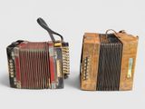 pair of old accordions with leather straps on each side of them