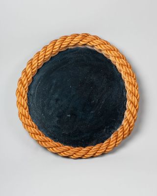 an image of a round mirror with a rope around it