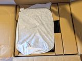 a box with a mattress inside of it on the floor