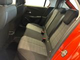 the back seats of a red car with a black seat belt