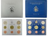 a set of four different british coins in a blue box