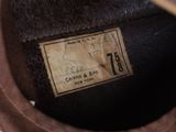 a close up of a brown hat with a label on it