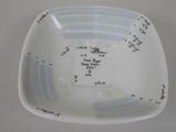 a white bowl with a measuring scale on it