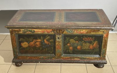 a wooden chest with a painting on it