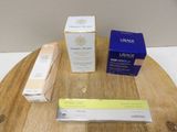 three boxes of skin care products sitting on a wooden table