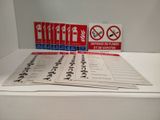 a lot of signs on the table that say no smoking